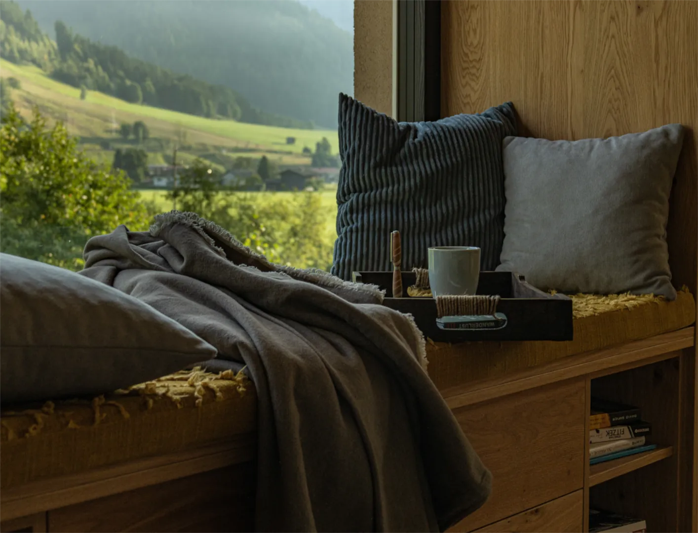 Liegefläche am Panoramafenster mit Frühstückstablett